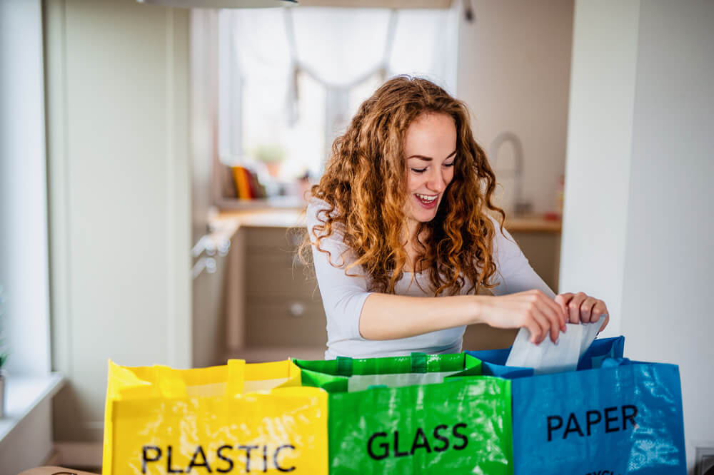 Woman recycling at home