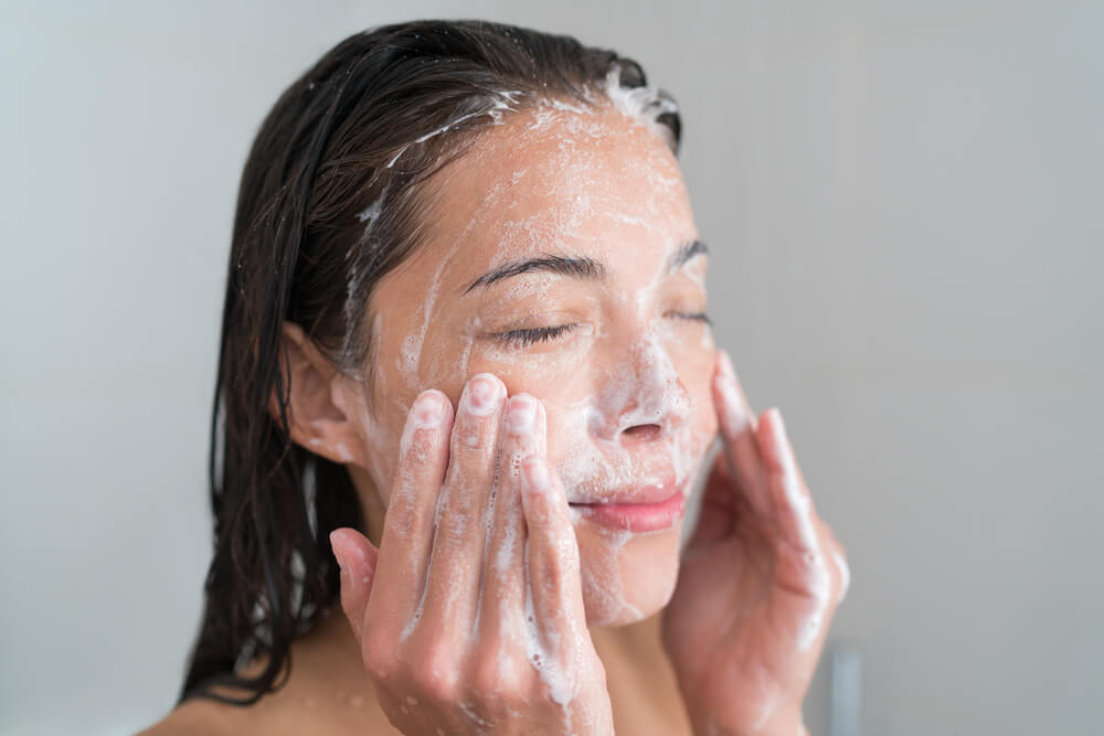 Woman cleansing skin