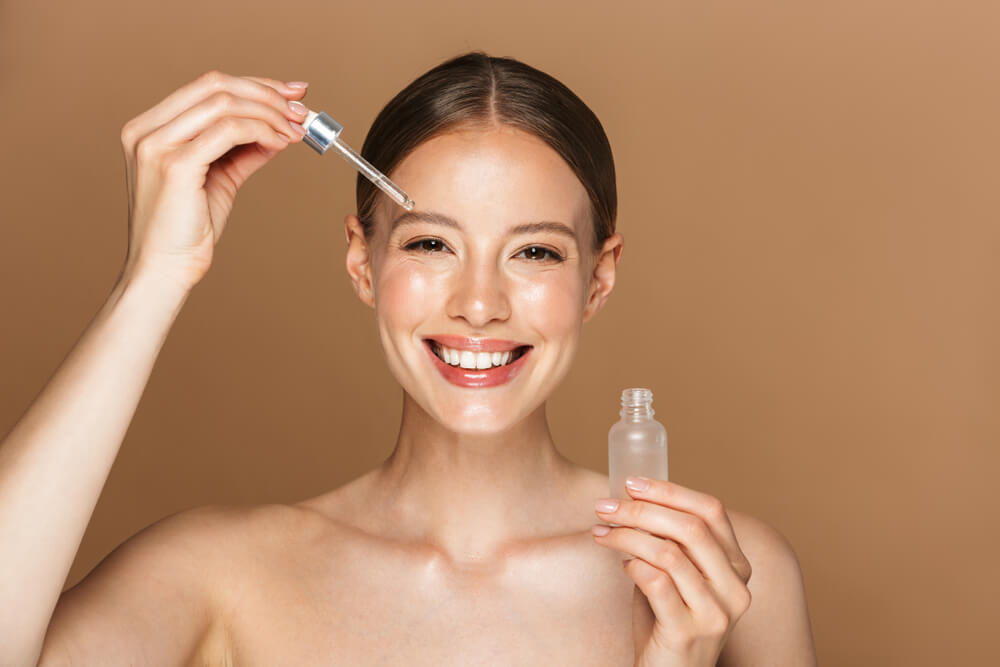 Woman applying face serum