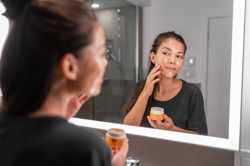 Woman applying facial peeling gel