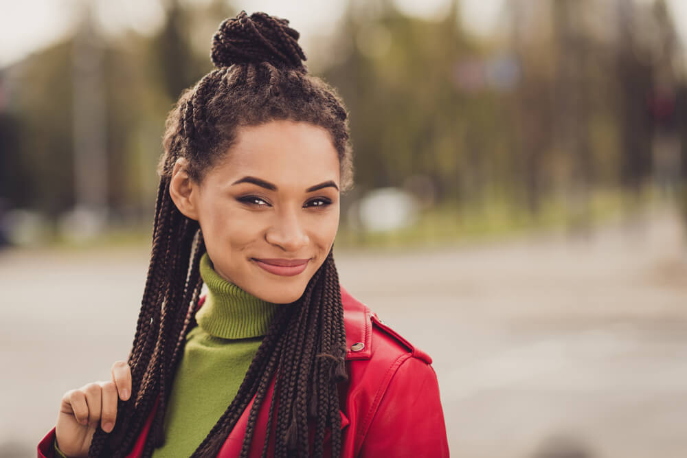 Woman with half bun showing hair trends for holidays