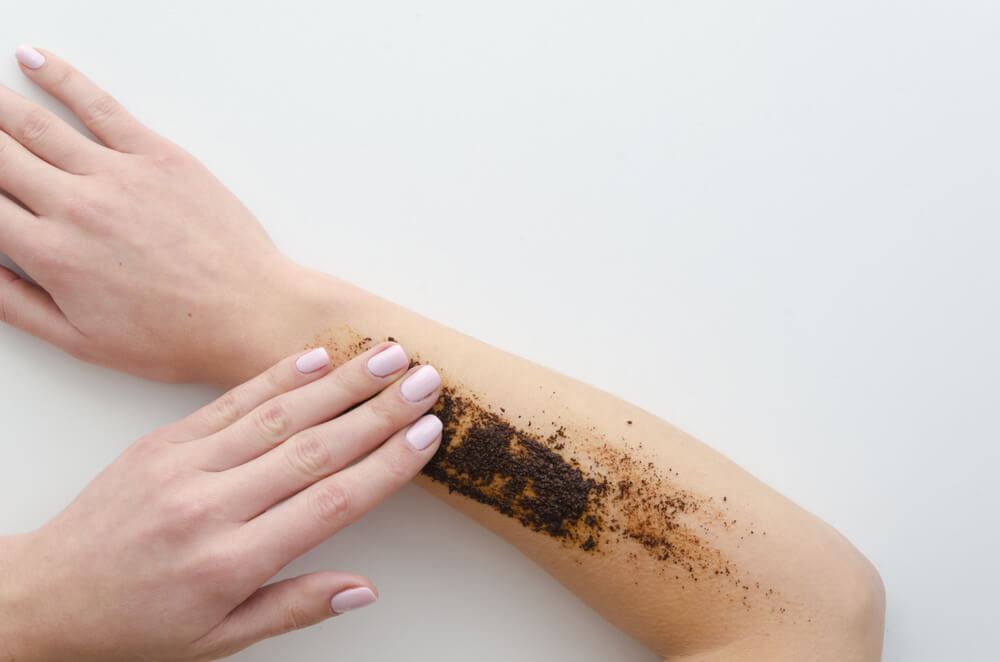 Woman learning how to use body scrub