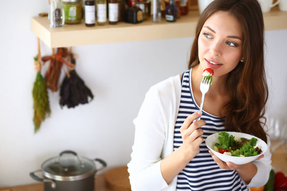 Woman eating salad