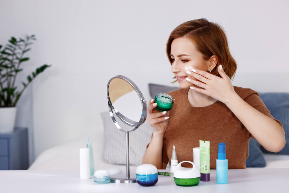 Woman applying face cream