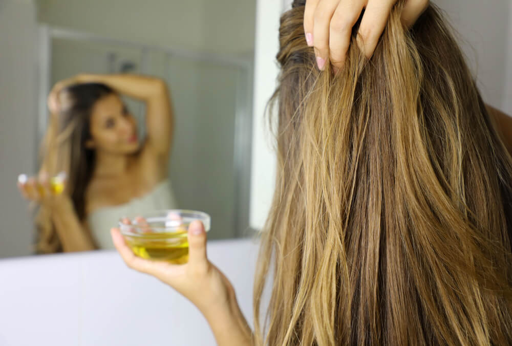 Woman putting olive oil in hair to make hair grow faster/thicker