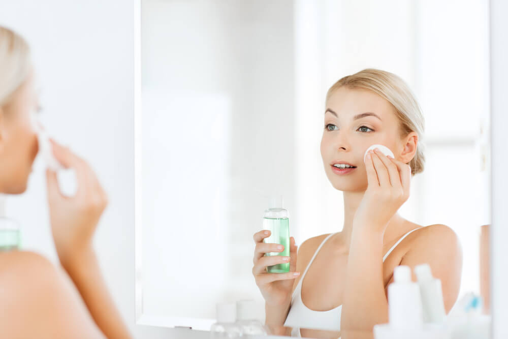 Woman cleansing skin