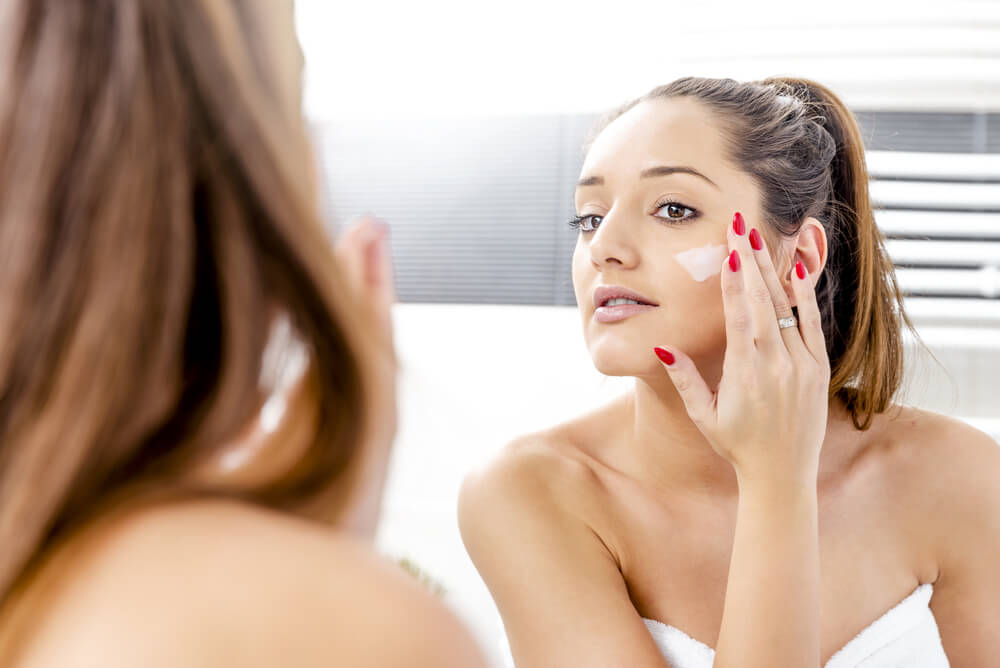 Woman applying face cream